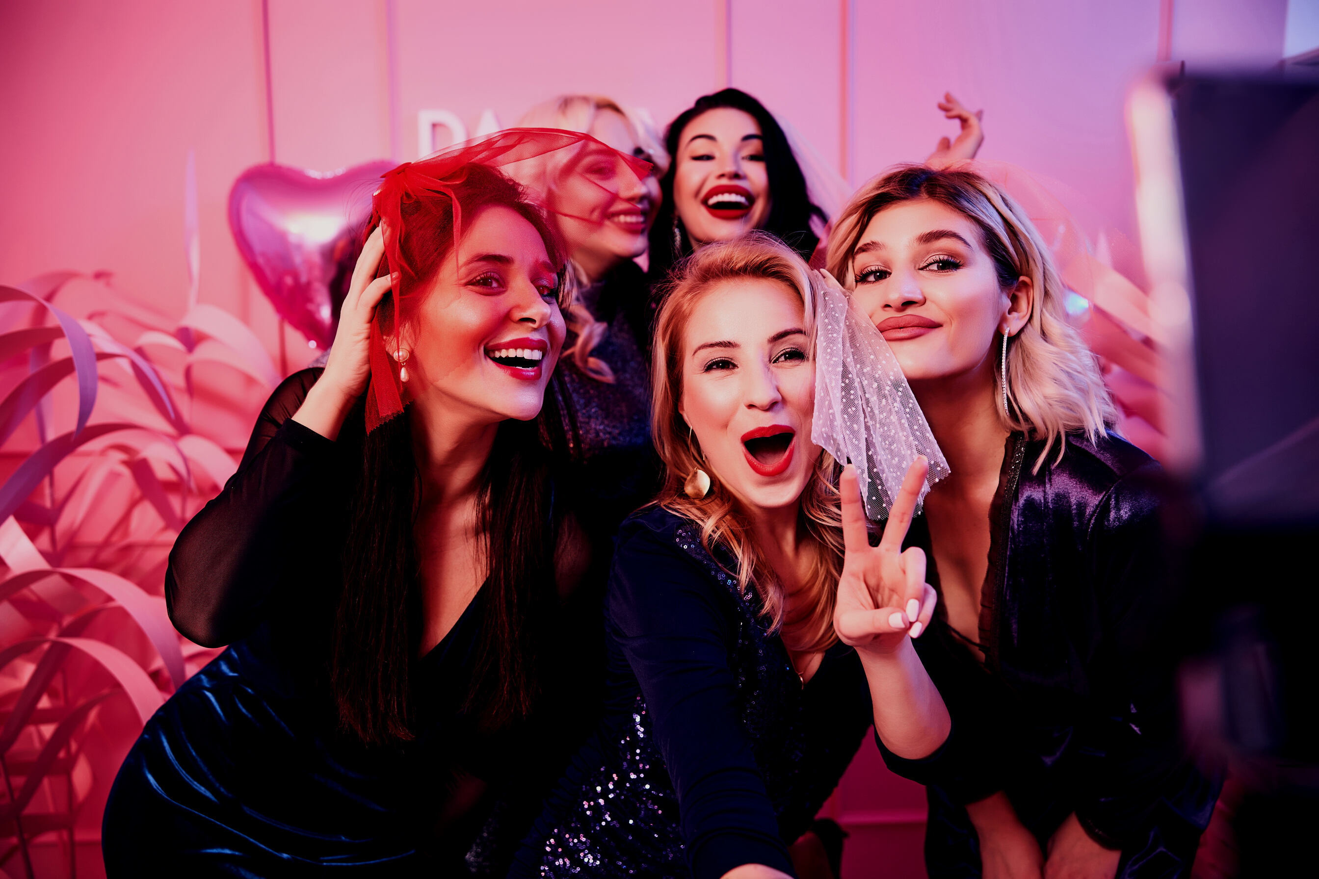 Cheerful ladies taking selfies at the bachelorette party